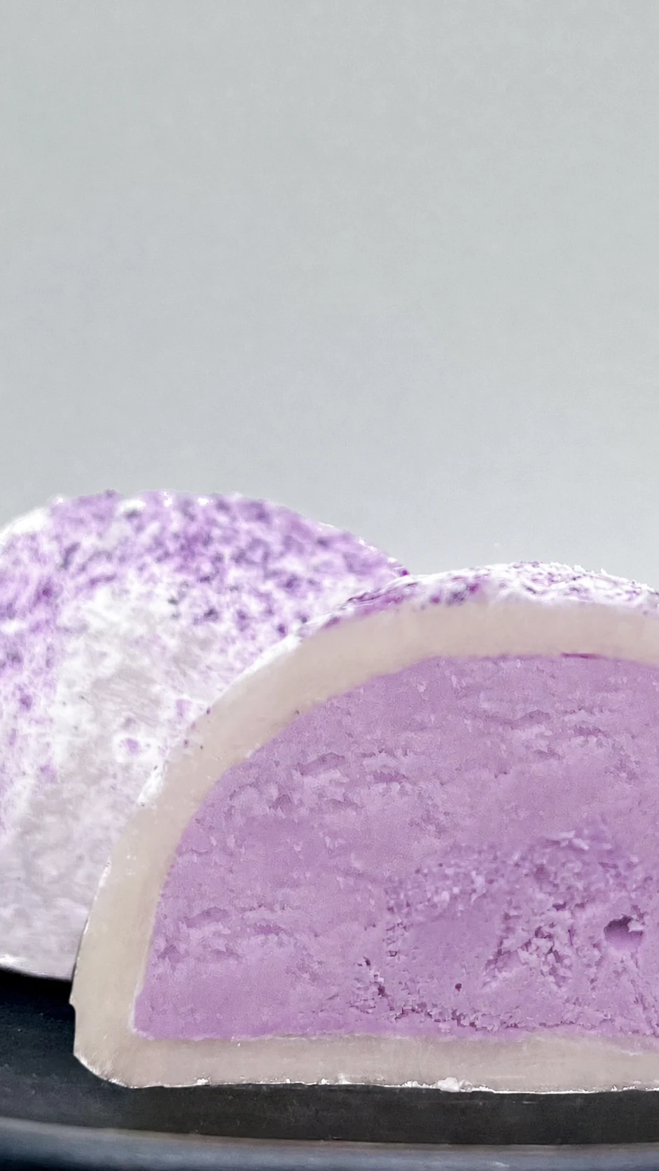 Text-free cut view of handmade Ochiai taro Mochiai with purple mousse filling
